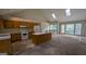 Bright kitchen with a center island and vaulted ceiling with skylights connecting to the living area at 9230 Melody Sw Cir, Covington, GA 30014