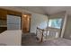 Kitchen featuring white appliances, stairs, and a view to the adjacent room, with ample lighting at 9230 Melody Sw Cir, Covington, GA 30014