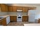 Functional kitchen with laminate counters, white appliances, and plenty of cabinet space at 9230 Melody Sw Cir, Covington, GA 30014