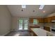 Cozy kitchen with a view of the deck, featuring ample countertop space and classic cabinetry at 9230 Melody Sw Cir, Covington, GA 30014