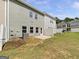 Backyard featuring a small concrete patio, lawn, and a partial privacy fence at 36 Crescent Chase, Dallas, GA 30157