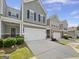 Three townhomes with gray siding and two car garages at 36 Crescent Chase, Dallas, GA 30157