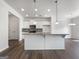 Bright kitchen featuring an island with seating, stainless appliances, and stylish backsplash at 36 Crescent Chase, Dallas, GA 30157