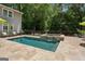 Backyard features a beautiful in-ground pool, spa, and stone patio at 750 Crest Valley Nw Dr, Sandy Springs, GA 30327