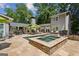 This home has an in-ground pool, hot tub, stone patio, and lush green landscaping at 750 Crest Valley Nw Dr, Sandy Springs, GA 30327