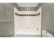 Bathroom features a tiled tub and shower combination with gold fixtures at 750 Crest Valley Nw Dr, Sandy Springs, GA 30327