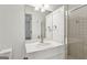 Bathroom features vanity with a mirror, sink, cabinet space, and a tiled shower at 750 Crest Valley Nw Dr, Sandy Springs, GA 30327