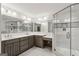 Bright bathroom features a double sink vanity with a glass-enclosed shower at 750 Crest Valley Nw Dr, Sandy Springs, GA 30327