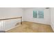 This carpeted room has a window and a railing and looks out over the home at 750 Crest Valley Nw Dr, Sandy Springs, GA 30327