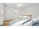 Bright staged bedroom features a ceiling fan, a plush bed, and an ensuite bathroom at 750 Crest Valley Nw Dr, Sandy Springs, GA 30327