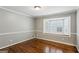 Bedroom features hardwood floors, gray walls, and a bay window with shutters at 750 Crest Valley Nw Dr, Sandy Springs, GA 30327
