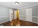 Bedroom features hardwood floors, gray walls, and two entry doors at 750 Crest Valley Nw Dr, Sandy Springs, GA 30327