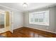 Bedroom features hardwood floors, gray walls, and a bay window with shutters at 750 Crest Valley Nw Dr, Sandy Springs, GA 30327