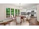 Dining room showing large window, hardwood floors, and adjacent kitchen area at 750 Crest Valley Nw Dr, Sandy Springs, GA 30327
