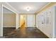 Spacious foyer with stone floors, white trim, and an arched doorway offering a glimpse into the home at 750 Crest Valley Nw Dr, Sandy Springs, GA 30327