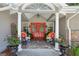 Inviting front porch with a red double door, stone accents, and cozy seating for a welcoming entrance at 750 Crest Valley Nw Dr, Sandy Springs, GA 30327