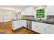 Kitchen with white cabinetry, stainless steel appliances, granite counter tops, mosaic backsplash and a window view to the outside at 750 Crest Valley Nw Dr, Sandy Springs, GA 30327