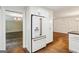 Kitchen with white cabinets, stainless steel refrigerator and a doorway view into another room with dark hardwood floors at 750 Crest Valley Nw Dr, Sandy Springs, GA 30327