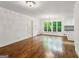 Hardwood floors and bright light fill this living room with adjacent kitchen at 750 Crest Valley Nw Dr, Sandy Springs, GA 30327