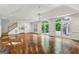 Bright living room with hardwood floors and large doors to a swimming pool at 750 Crest Valley Nw Dr, Sandy Springs, GA 30327