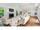 Living room with fireplace, large picture windows, hardwood floors, staircase, white sofas and a modern farmhouse feel at 750 Crest Valley Nw Dr, Sandy Springs, GA 30327