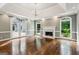 Bright living room with a fireplace and exterior walkout doors at 750 Crest Valley Nw Dr, Sandy Springs, GA 30327
