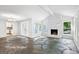 Bright living room with a stone fireplace, flagstone flooring, and large windows at 750 Crest Valley Nw Dr, Sandy Springs, GA 30327