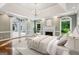 A virtually staged main bedroom with a fireplace and walkout doors at 750 Crest Valley Nw Dr, Sandy Springs, GA 30327