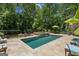 A backyard oasis featuring a beautiful pool, spa, lounge chairs, and patio furniture, perfect for relaxing and entertaining at 750 Crest Valley Nw Dr, Sandy Springs, GA 30327