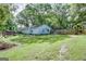 A backyard featuring mature trees, green grass, and a wood fence at 4236 Florida Nw Ave, Atlanta, GA 30360