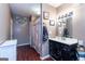 Bathroom featuring dark wood-look floors, large mirror, and shower with ruffled curtain at 4236 Florida Nw Ave, Atlanta, GA 30360