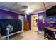 A bedroom featuring purple paneled walls, hard wood floors and plenty of natural light at 4236 Florida Nw Ave, Atlanta, GA 30360