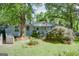 Inviting home with a well-manicured front yard and mature trees, offering curb appeal at 4236 Florida Nw Ave, Atlanta, GA 30360