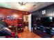 A living room featuring hardwood floors and red paneled wall with large television at 4236 Florida Nw Ave, Atlanta, GA 30360