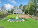 Expansive backyard with in-ground pool, lounge chairs, and a lush lawn at 103 Maddox Rd, Buford, GA 30518