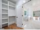 Bright bathroom with elegant soaking tub and glass shower open to closet at 103 Maddox Rd, Buford, GA 30518