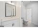 Well-lit bathroom featuring a modern vanity, elegant mirror, and a toilet at 103 Maddox Rd, Buford, GA 30518