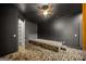 Modern bedroom with tiered mattress, accent wall, and walk-in closet at 103 Maddox Rd, Buford, GA 30518