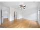 Spacious bedroom featuring hardwood floors, ceiling fan, and a walk-in closet at 103 Maddox Rd, Buford, GA 30518