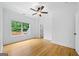 Bright bedroom with hardwood floors, ceiling fan, and natural light from a window at 103 Maddox Rd, Buford, GA 30518