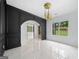 Elegant entryway featuring dark wood paneling, marble floors, and modern chandelier at 103 Maddox Rd, Buford, GA 30518