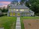 Stunning two-story home with a well-manicured lawn and inviting walkway to the front entrance at 103 Maddox Rd, Buford, GA 30518