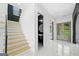Staircase and foyer featuring marble floors and black and white walls at 103 Maddox Rd, Buford, GA 30518