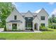 Beautiful two-story home with a well-manicured lawn, brick exterior, and elegant front facade at 103 Maddox Rd, Buford, GA 30518
