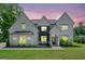 Beautiful two-story home with a well-manicured lawn, brick exterior, and elegant front facade at 103 Maddox Rd, Buford, GA 30518
