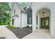 Charming white-brick home with a well-manicured lawn, arch entryway, and elegant front facade at 103 Maddox Rd, Buford, GA 30518