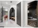 Hallway with mud room, coat rack, and doorway to a modern living room at 103 Maddox Rd, Buford, GA 30518