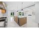 Bright kitchen featuring marble floors, a large island, and stainless steel appliances at 103 Maddox Rd, Buford, GA 30518