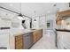 Bright, open-concept kitchen with a central island, stainless steel appliances, and stylish pendant lighting at 103 Maddox Rd, Buford, GA 30518