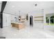 Open concept kitchen with island, marble countertops, custom cabinets, and stainless appliances at 103 Maddox Rd, Buford, GA 30518